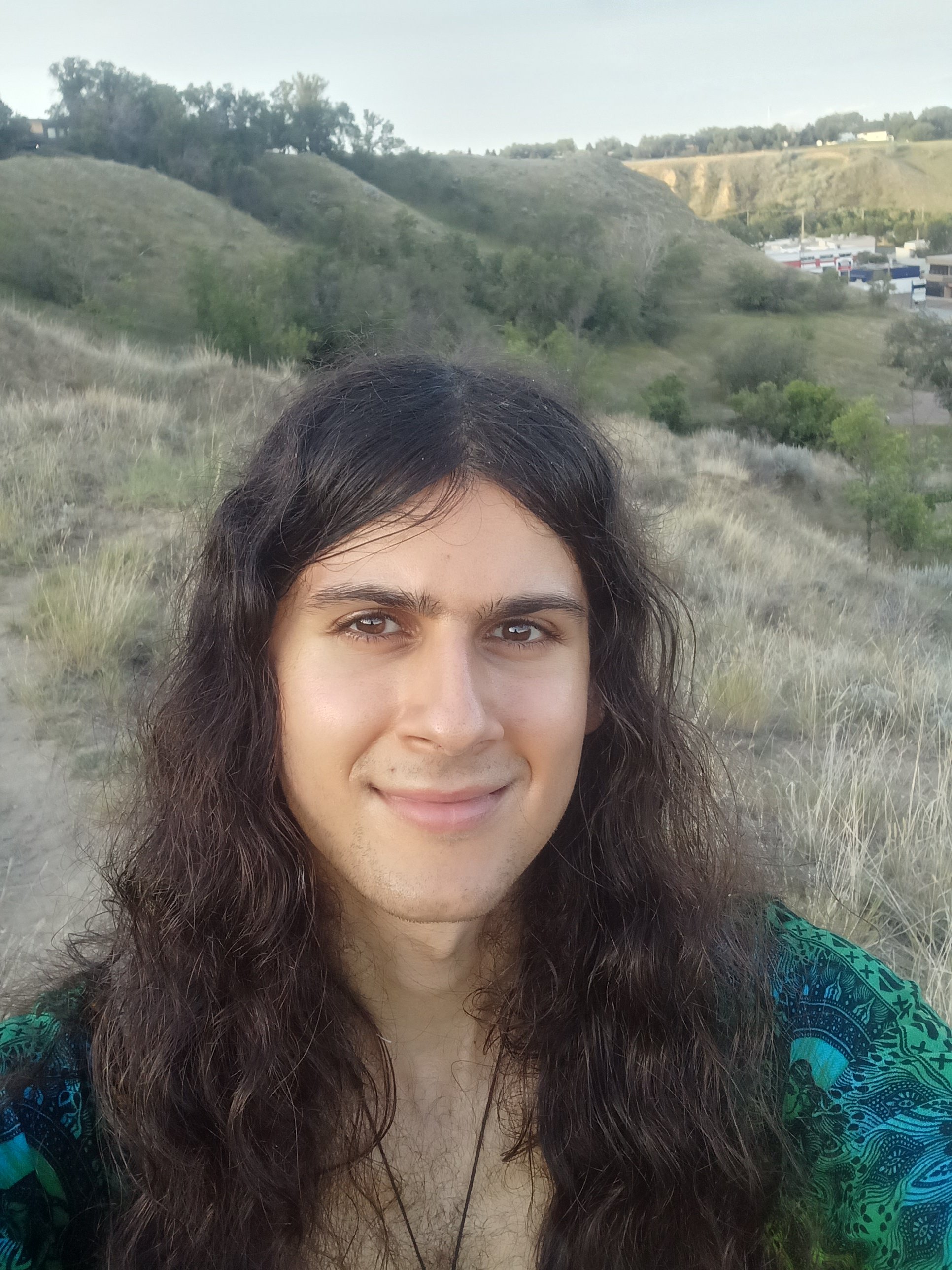 Leon smiling on a hillside in Alberta